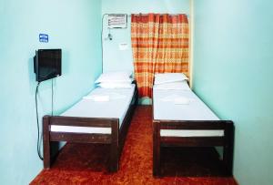 Postel nebo postele na pokoji v ubytování RedDoorz at D128 Lodge Cagayan Valley