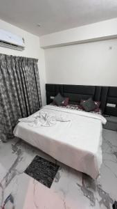 a bed in a room with a marble floor at Millennium Suites in Orchha