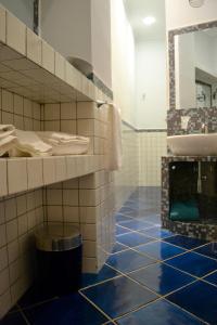 a bathroom with a blue tiled floor and a sink at Dimora Tafuri in Salerno +40 photos