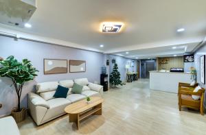 a living room with a couch and a table at AB House in Bangkok