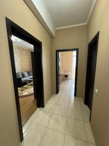 a hallway with two doors leading to a living room at Harmony apartment in Chişinău +2 photos