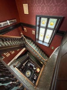 an overhead view of a staircase with a stained glass window at Headlands Hotel in Llandudno