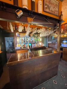 a bar with a large wooden counter top at Headlands Hotel in Llandudno
