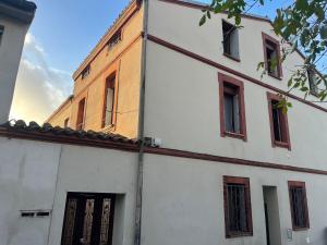 a white building with windows on the side of it at Le Refuge mysterieux d'Harry proche Gare Toulouse in Toulouse
