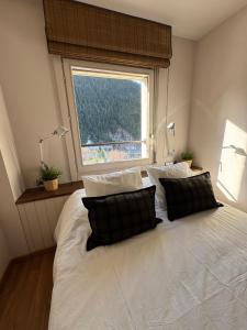 a bedroom with a large white bed with a window at Baqueira1500, apartamento con vistas a pie de pistas in Naut Aran