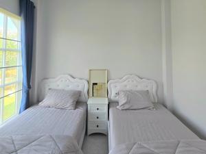 Postel nebo postele na pokoji v ubytování Baan Fah Chiang Rai