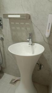 a bathroom with a white sink in a room at JD Heritage Inn in Bareilly