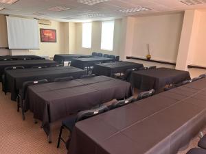 a conference room with black tables and chairs at Hotel San Carlos Tequisquiapan in Tequisquiapan +139 photos