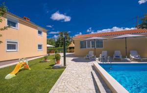 a backyard with a swimming pool and a house and a house at HOUSE Nevenka in Nova Vas