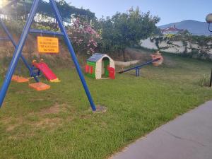 a park with a playground with a slide at Blue Sea Studios in Limenaria
