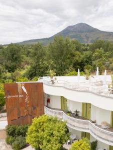 an aerial view of a building with a mountain in the background at Vesuvio Inn Bed & Wine Experience in Boscotrecase