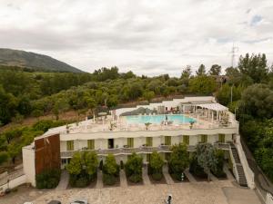 an aerial view of a building with a swimming pool at Vesuvio Inn Bed & Wine Experience in Boscotrecase