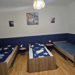 A bed or beds in a room at Orsi Apartman / vendegház