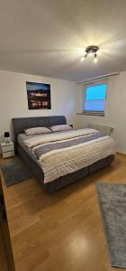 a bedroom with a large bed and a window at Ferienwohnung Alte Wache 12 DG in Holzminden