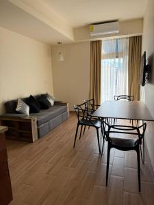 a living room with a couch and a table and chairs at Hotel San Carlos Tequisquiapan in Tequisquiapan