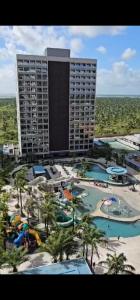 a view of a hotel with pools and a resort at Apto Salinas Premium - 2 quartos - 1 suíte in Salinópolis