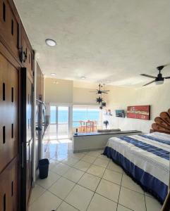 a bedroom with a bed and a view of the ocean at Oceanfront-Ocean View in Bucerias Casita Oasis Condo - Large Studio in Bucerías