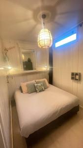 a bed in a room with a light on it at Kust 3 in Egmond aan Zee
