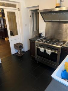 a kitchen with a stove and a counter top at My Home in London