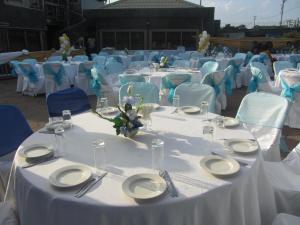 a group of tables and chairs with white plates and napkins at Eastgate Hotel in Accra +38 photos