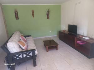 a living room with a couch and a coffee table at Casa Quequen in Quequén