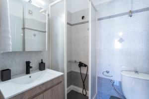 a bathroom with a sink and a shower at City Center Appartment in Mytilini +287 photos