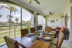 a dining room with a table and chairs and a balcony at El Tigre, Green Bay I Shared Pool in Nuevo Vallarta 