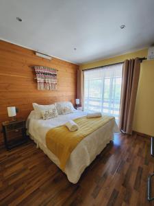 a bedroom with a large bed and a large window at Hotel Kernayel in Pucón +22 photos