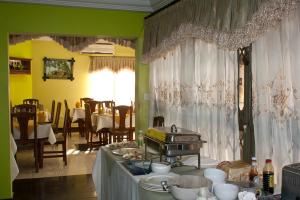 a dining room with a table with food on it at Eastgate Hotel in Accra