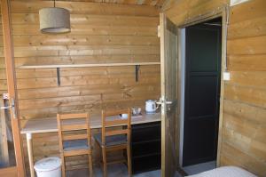 a small room with a table and chairs and a door at Hotel Camping sur Yonne in Épiry +9 photos