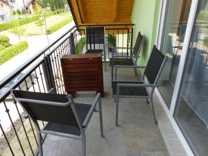 a row of chairs sitting on a balcony at Ferienhaus Roebel Mueritz in Marienfelde