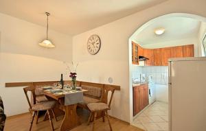a kitchen with a table and a clock on the wall at HOUSE Nevenka in Nova Vas