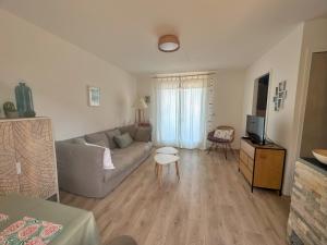 a living room with a couch and a tv at Appartement Calvi A Moresca in Calvi
