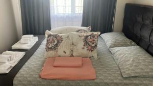 a bed with two pillows and a tray on it at New and modern appartament in Greece in Paralia Katerinis +32 photos