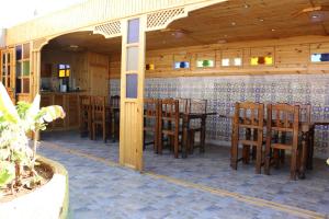 a dining room with wooden tables and chairs at Riad Les Chtis D'Agadir in Agadir