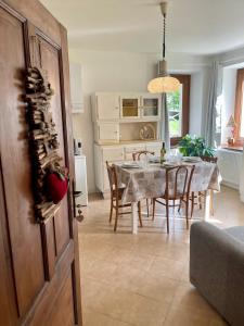 a kitchen and dining room with a table and chairs at Garden Dream in Valle di Cadore