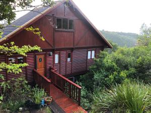 a wooden cabin with a porch and a deck at Forest Edge Hideaway -Six on Imbali in George +47 photos