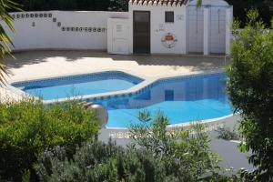 a swimming pool in front of a house at Casa Caracol in Praia do Carvoeiro