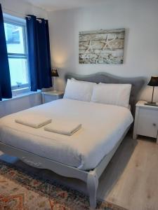 a bed with white sheets and pillows in a bedroom at Number Four in Brighton & Hove