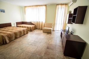 Postel nebo postele na pokoji v ubytování Family hotel Apolon