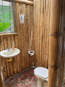 a wooden bathroom with a toilet and a sink at Cabañas Amanvari in El Retiro