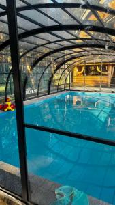 a large blue swimming pool with a tunnel at Ośrodek u Polaka-domek góralski in Radkowice
