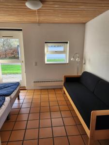 a living room with a couch and a window at Landal søhøjlandet in Gjern