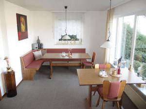 a living room with a couch and a table and chairs at Pension Talblick in Höchst im Odenwald