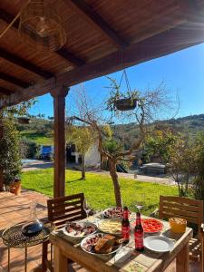 a table with food and drinks on a patio at FINCA LAS DEHESILLAS in Monesterio
