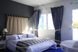 a bedroom with two beds and a window at Marina Cap Monastir- Appart'Hôtel in Monastir