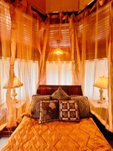 a bedroom with a bed with pillows and curtains at Casa Victoriana Aeropuerto in San Juan Arriba +67 photos