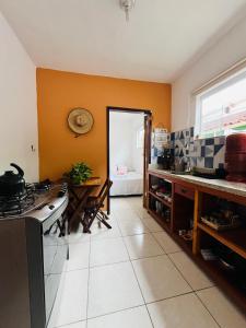 a kitchen with a sink and a table in a room at Microcasa Aconchego Paraty in Paraty