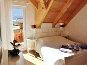 a bedroom with a large bed and a window at Villa Sonnenpiste in Kötschach