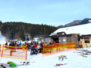 a group of people standing around a ski resort at Villa Sonnenpiste in Kötschach
